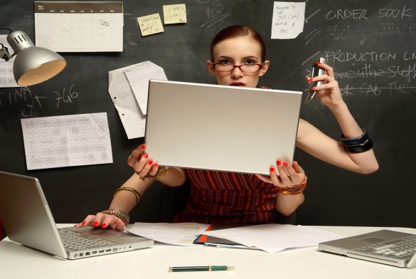 Young Woman Using Three Laptops With Four Hands, Smiling, Portrait