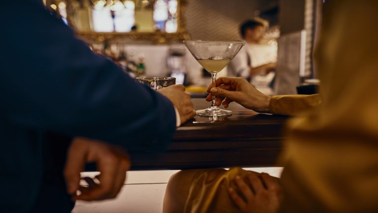 Close Up Of Elegant Couple Having A Drink At The Counter In A Bar