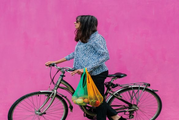 Woman With Classic Dutch Bike With Reusable Bags With A Sustainable Purchase On Pink Background