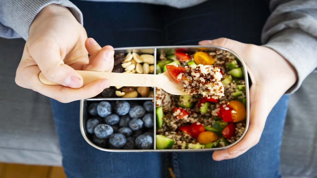 Lunchbox With Quinoa Salad With Tomato And Cucumber, Blue Berry And Trail Mix